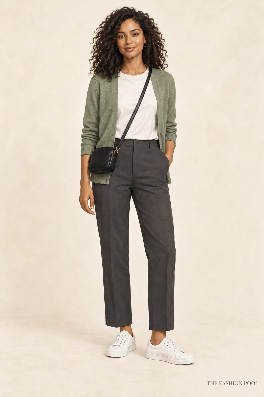 Woman illustrated in an open sage cardigan, ivory crew-neck tee, charcoal straight-leg trousers, white sneakers and a small black crossbody.